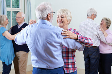 Group Of Seniors Enjoying Dancing Club Together